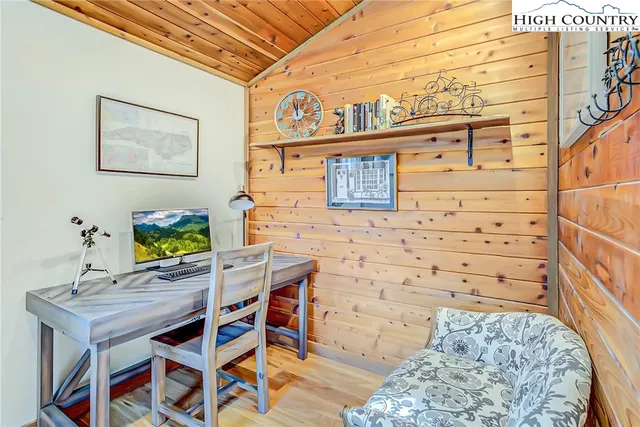 a view of a dining room with furniture large windows and wooden floor