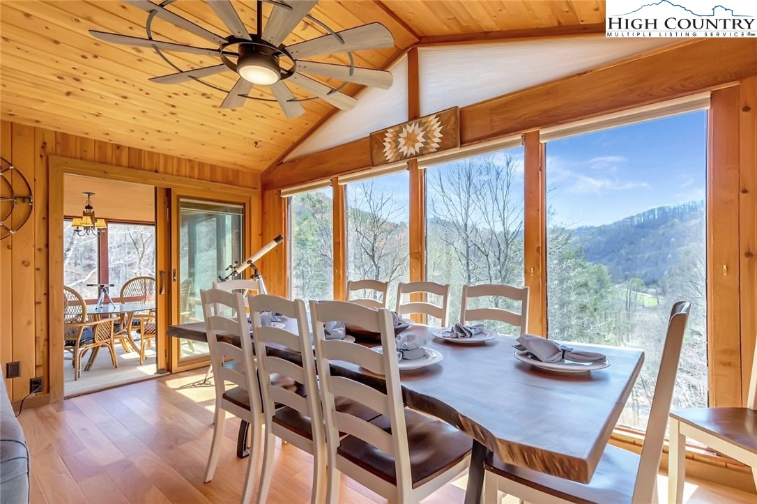 389 Auborn Trivette Road Sugar Grove, NC 28679 - Photo 18 of 49 a view of a dining room with furniture large windows and wooden floor