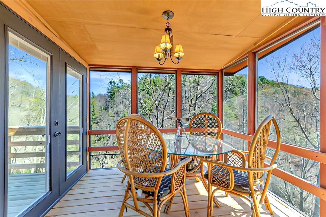 389 Auborn Trivette Road Sugar Grove, NC 28679 - Photo 19 of 49 a view of a balcony with table and chairs