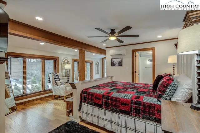 a bedroom with a bed and a chandelier