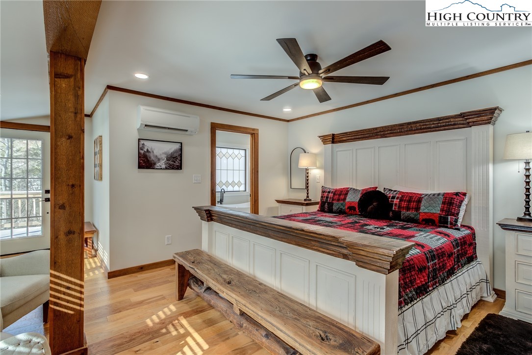 389 Auborn Trivette Road Sugar Grove, NC 28679 - Photo 21 of 49 a bedroom with a bed and a chandelier