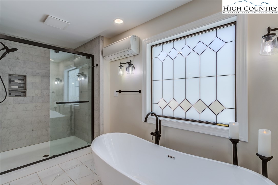 389 Auborn Trivette Road Sugar Grove, NC 28679 - Photo 22 of 49 a bathroom with a sink and a shower