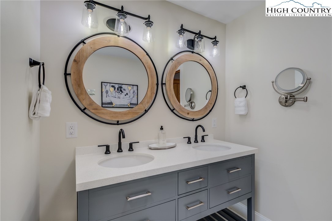389 Auborn Trivette Road Sugar Grove, NC 28679 - Photo 23 of 49 a bathroom with a granite countertop double vanity sink and a mirror
