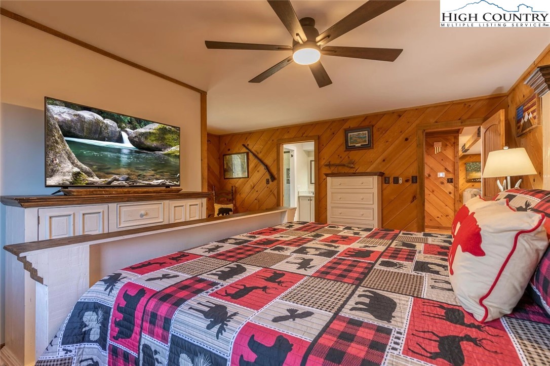 389 Auborn Trivette Road Sugar Grove, NC 28679 - Photo 25 of 49 a bedroom with a bed and a flat screen tv