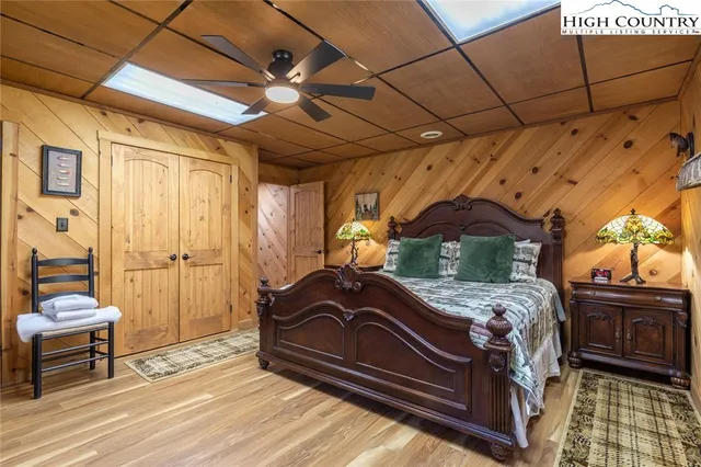 a bedroom with bed and wooden floor