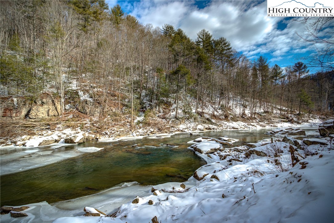 389 Auborn Trivette Road Sugar Grove, NC 28679 - Photo 42 of 49 a view of a lake from a yard