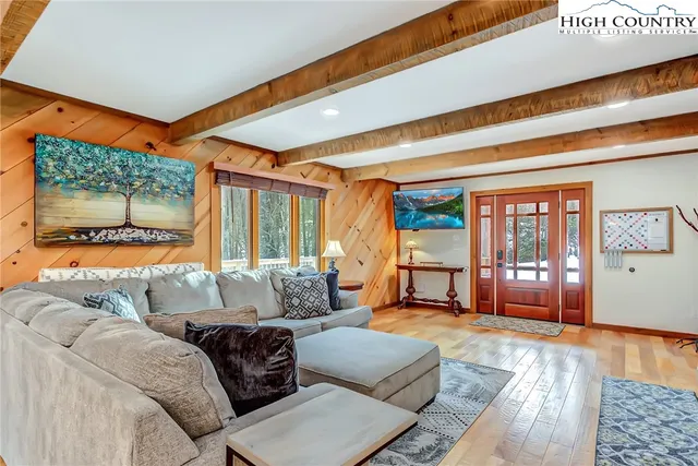 a kitchen with stainless steel appliances kitchen island granite countertop a table chairs sink and cabinets