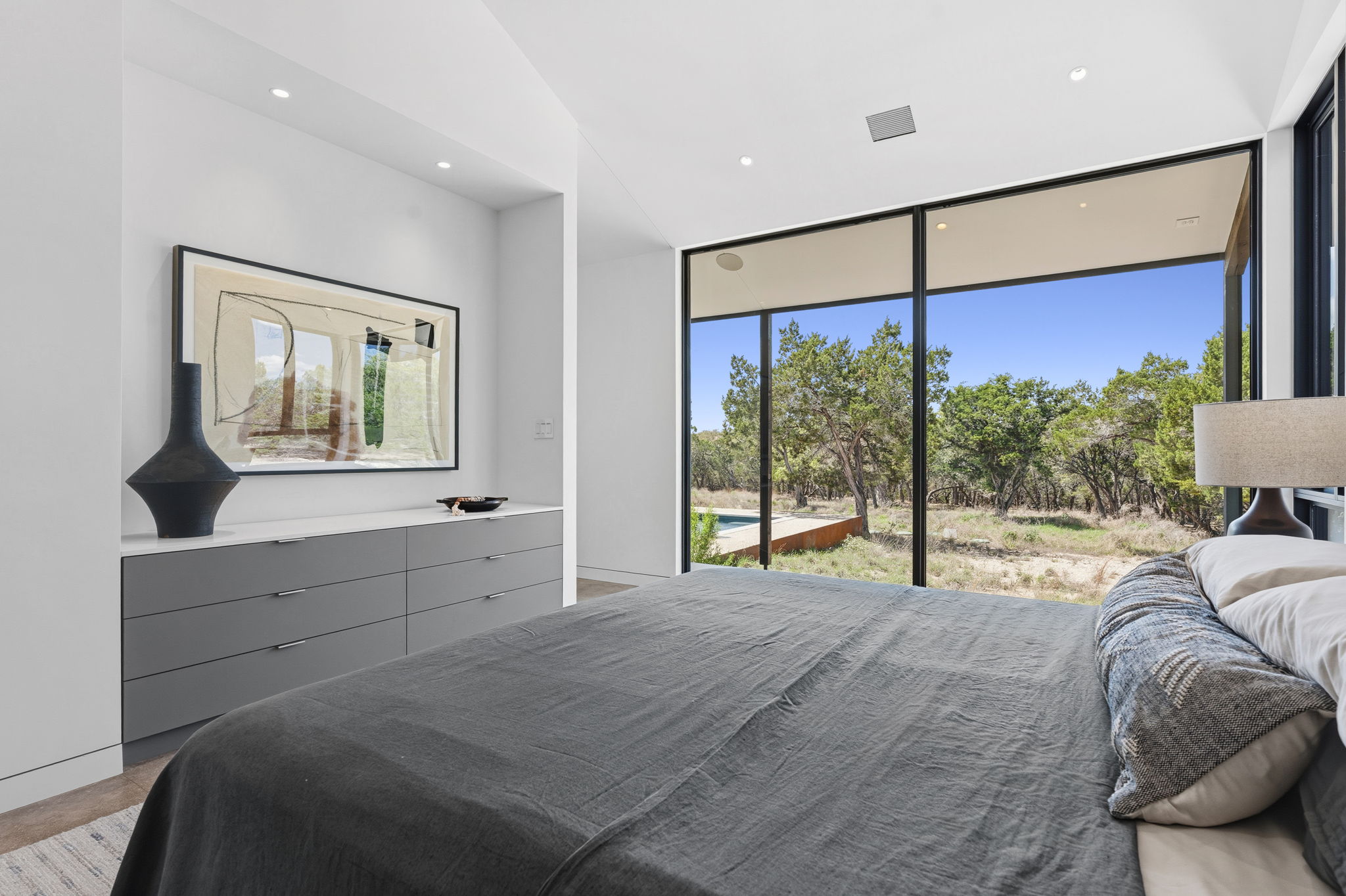 10982 Long Branch Drive Austin, TX 78736 - Photo 18 of 40 a bed room with a bed and a large window