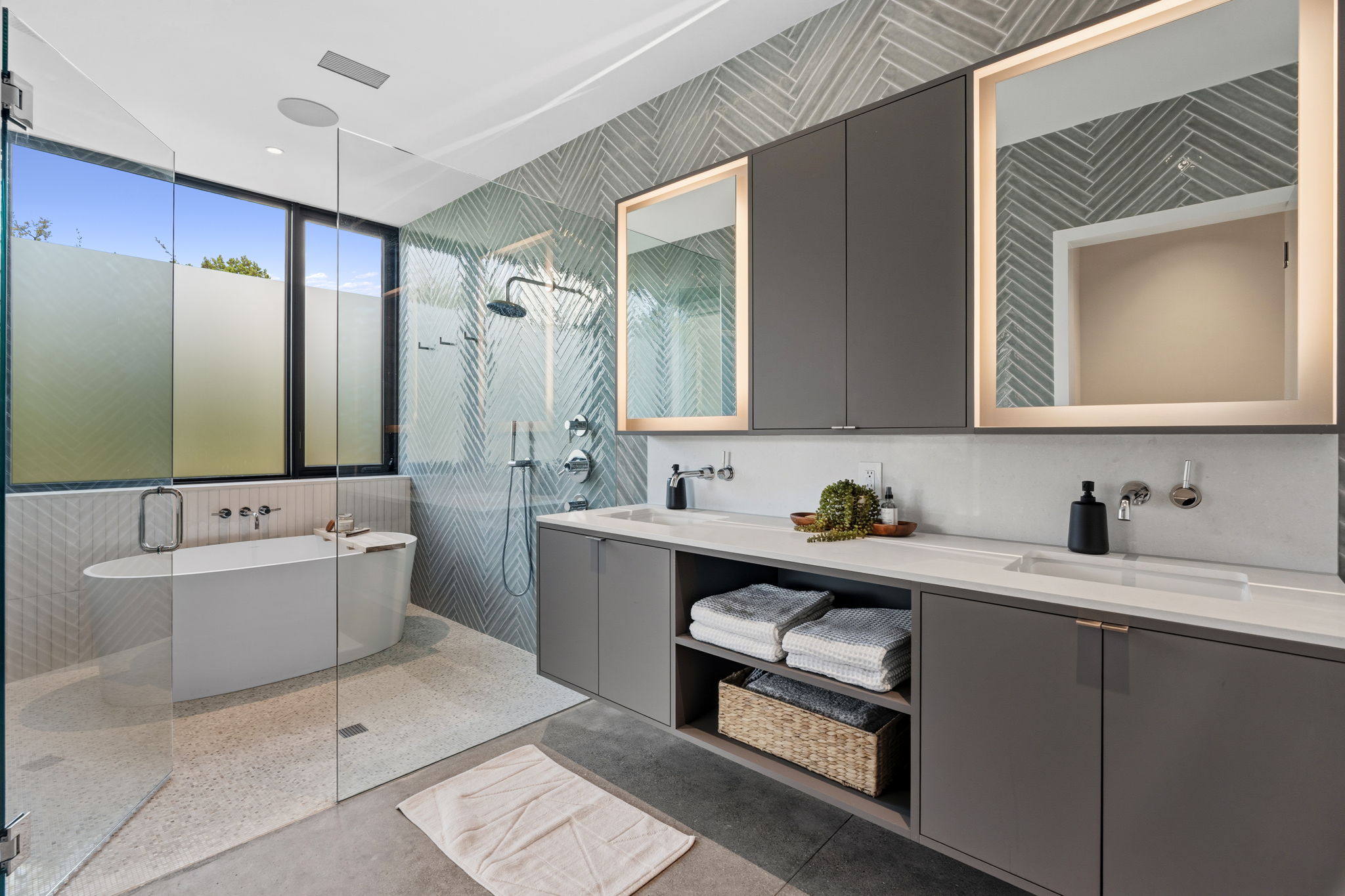 10982 Long Branch Drive Austin, TX 78736 - Photo 21 of 40 a bathroom with a tub a sink double vanity and a mirror