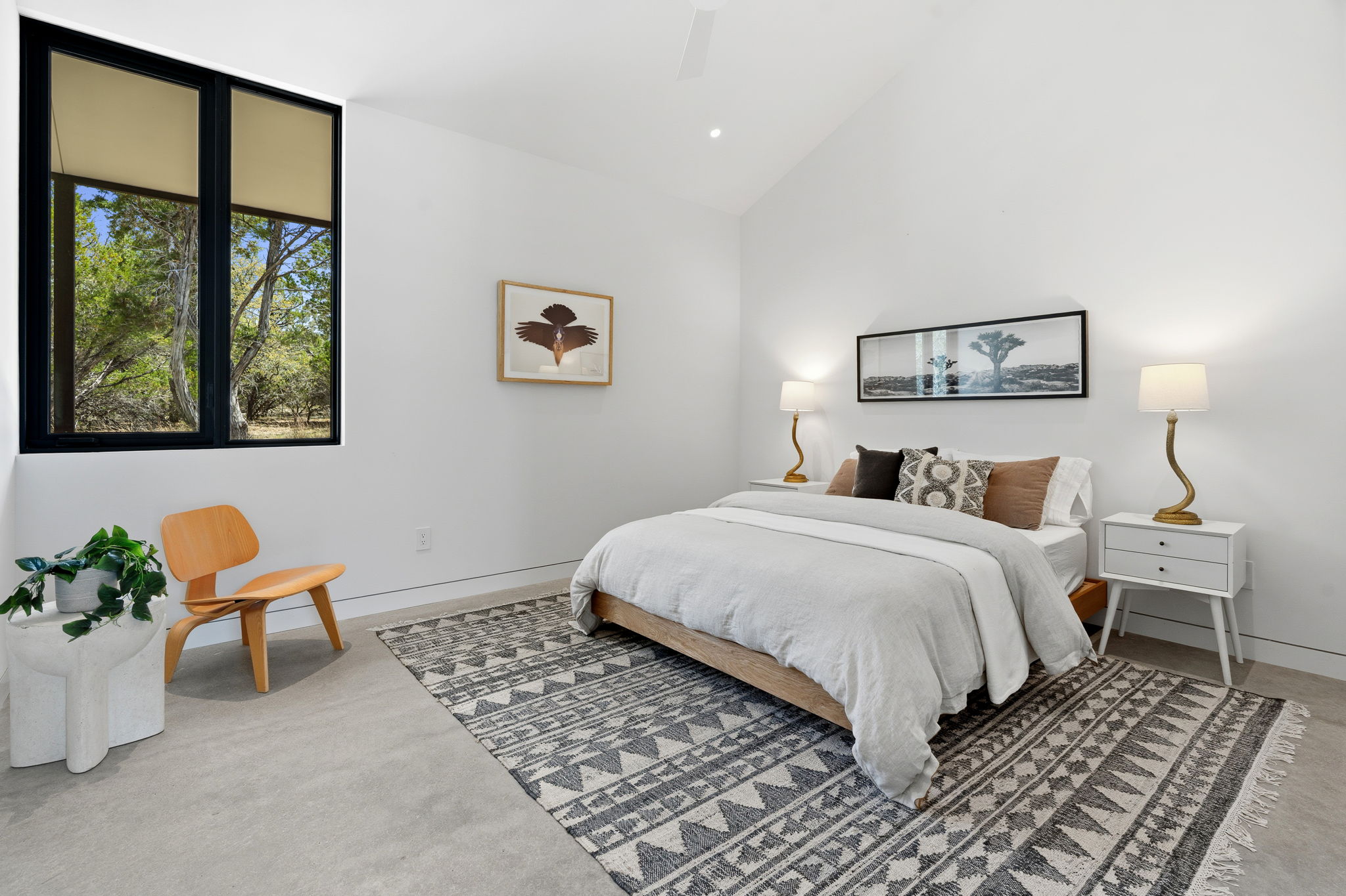 10982 Long Branch Drive Austin, TX 78736 - Photo 22 of 40 a bedroom with a bed and a painting on the wall