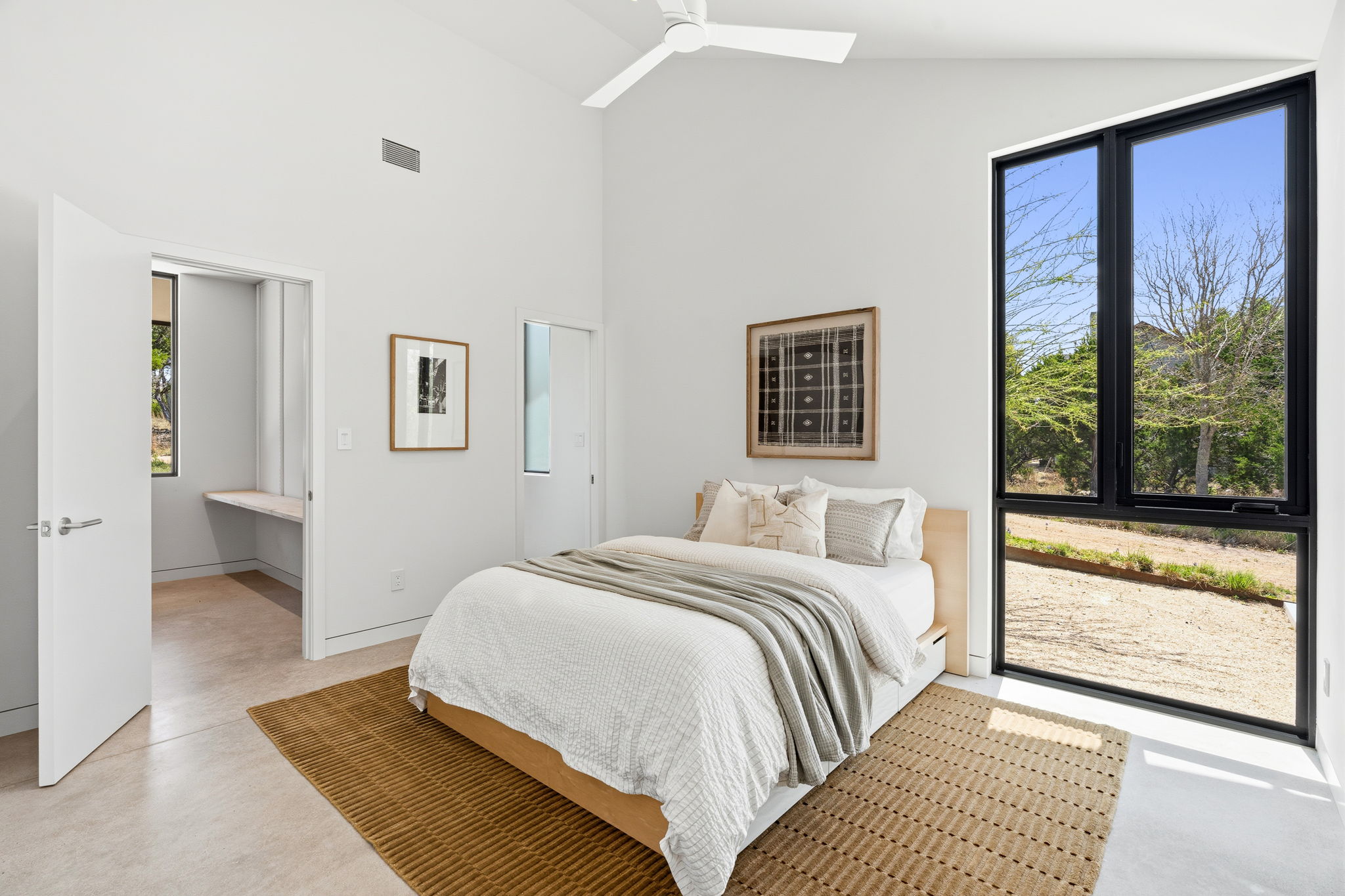 10982 Long Branch Drive Austin, TX 78736 - Photo 26 of 40 a bedroom with a large bed and a window