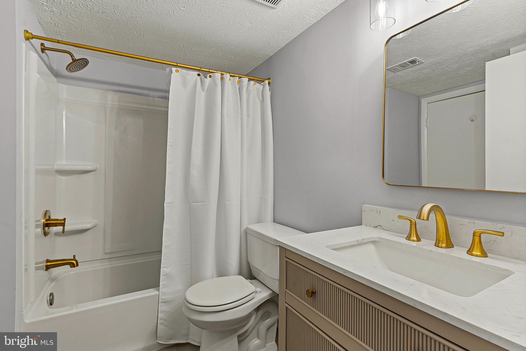 8005 Mandan Road, Unit 302 Greenbelt, MD 20770 - Photo 17 of 22 a bathroom with a sink a toilet and shower