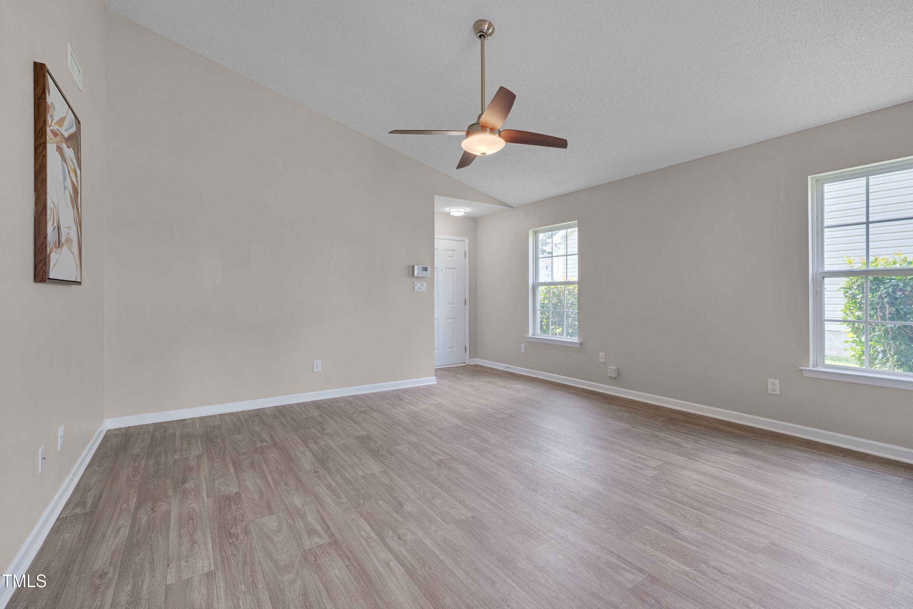 5000 Silverdene Street Raleigh, NC 27616 - Photo 3 of 12 a view of an empty room with wooden floor and a window