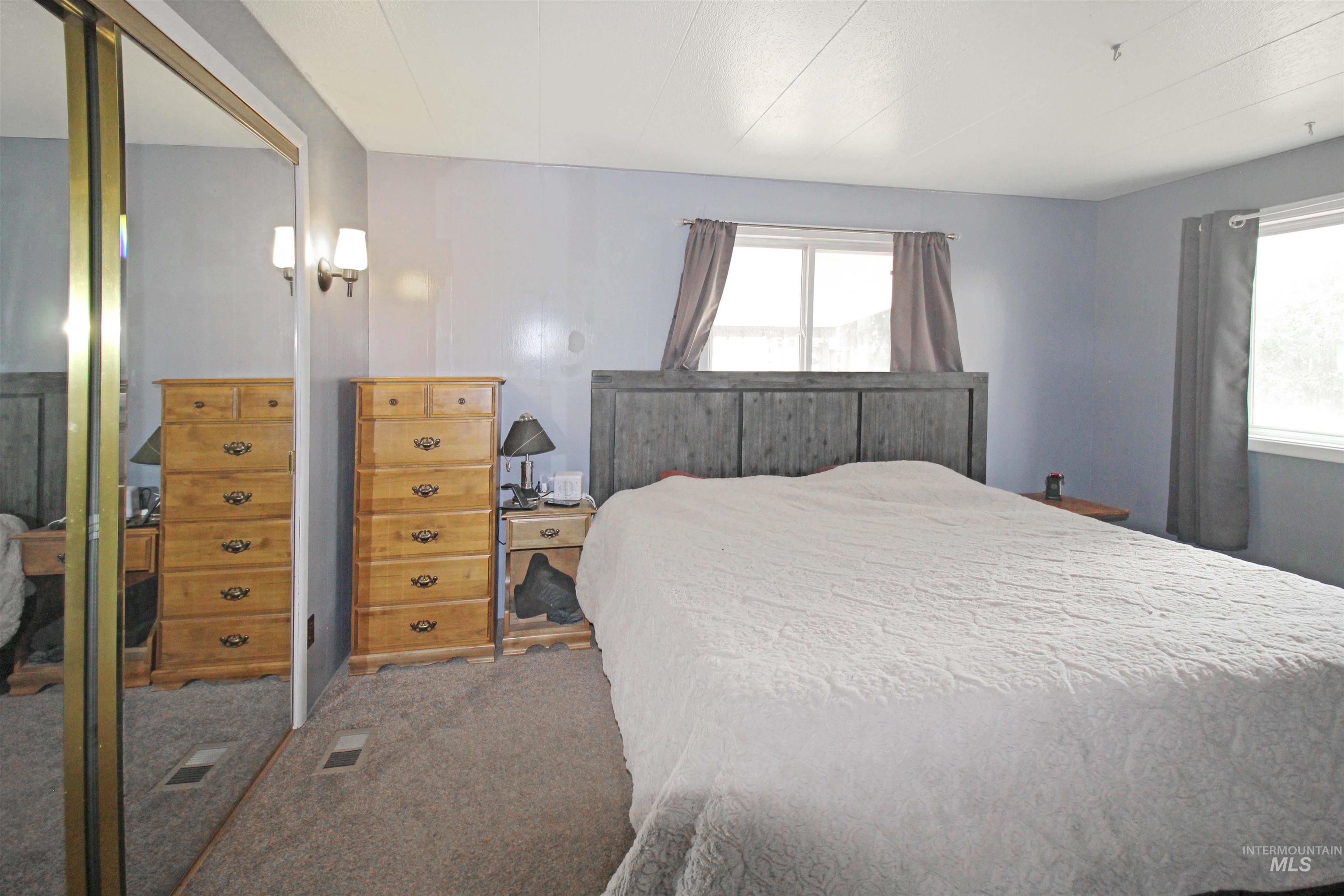 1265 Pioneer Road Weiser, ID 83672 - Photo 16 of 29 Bedroom featuring light blue walls and gray carpeting