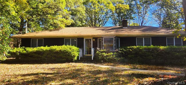 a front view of house with yard and green space