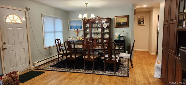 a view of a dining room with furniture and chandelier