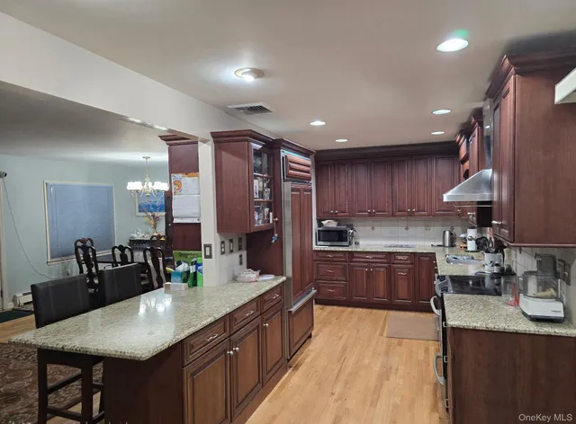 a kitchen with stainless steel appliances granite countertop a sink counter space and cabinets