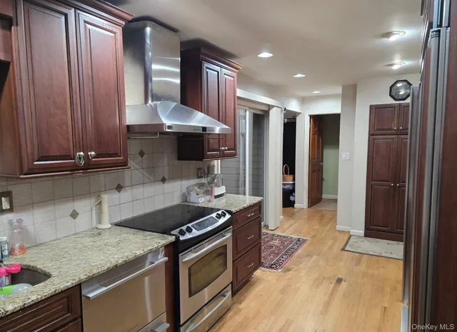 a kitchen with stainless steel appliances granite countertop a stove and a sink