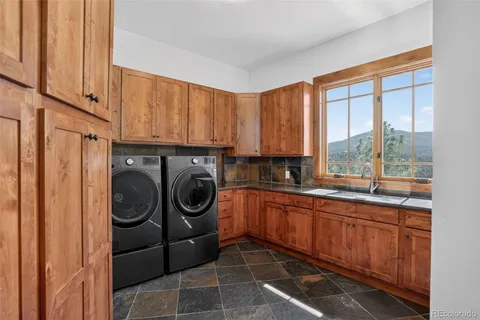 a utility room with sink dryer and washer