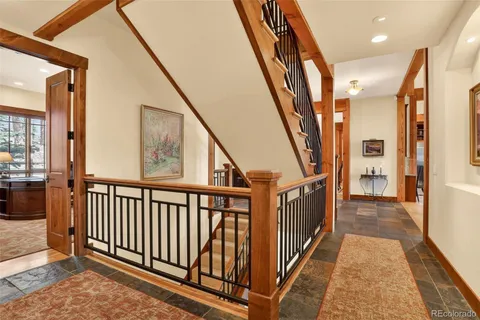 a view of an entryway with wooden floor and stairs
