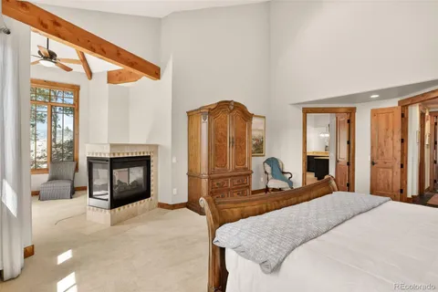 a bedroom with a bed and dresser with mirror