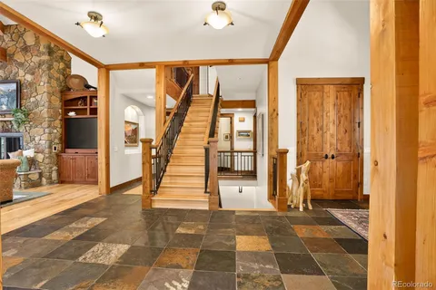 a view of a hallway with wooden floor and windows