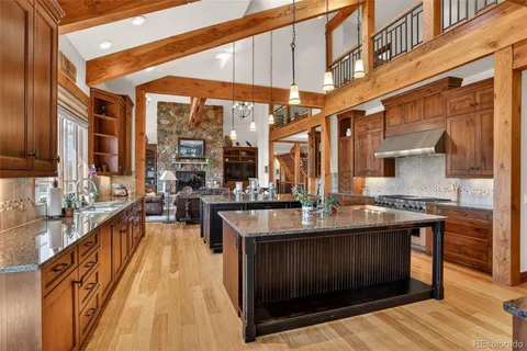 a kitchen with a stove a sink and a wooden cabinets