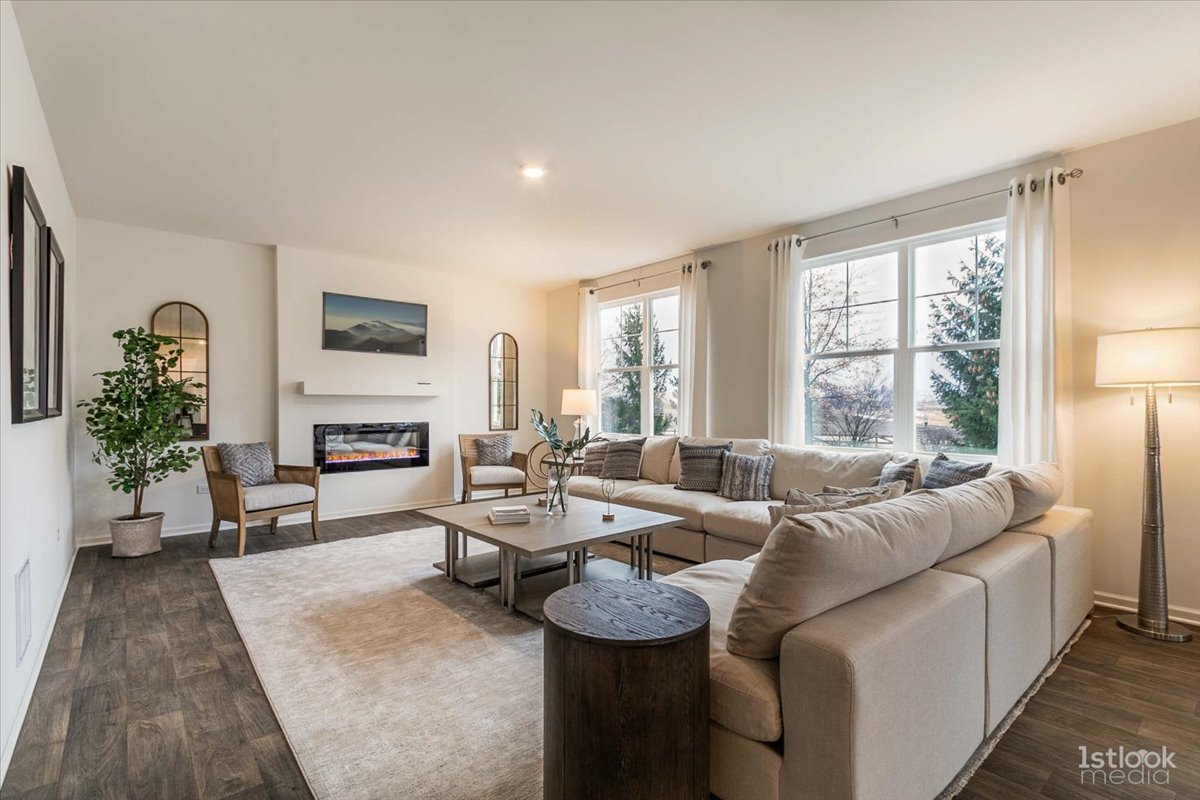 10453 Privet Drive St. John, IN 46307 - Photo 11 of 37 a living room with furniture a large window and a fireplace