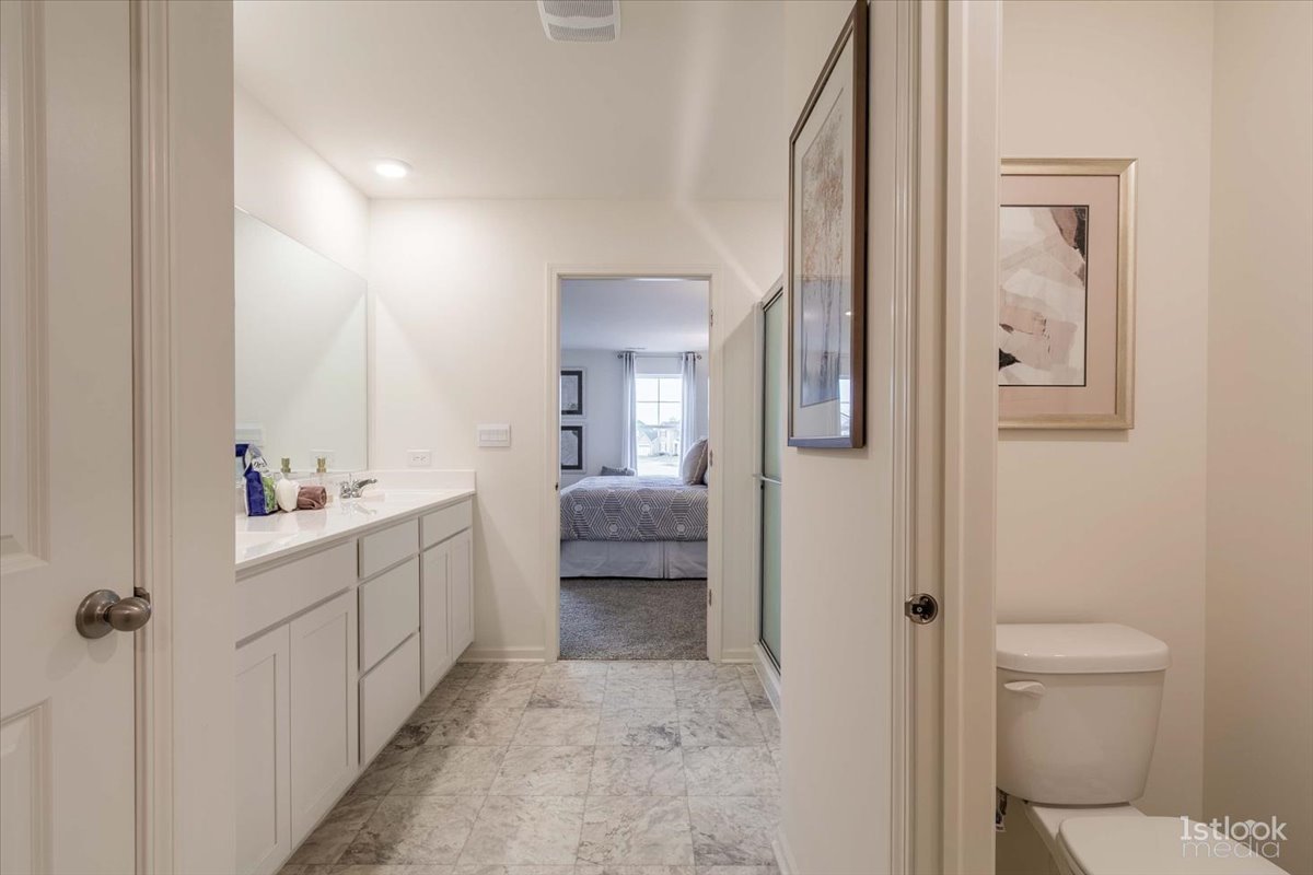 10453 Privet Drive St. John, IN 46307 - Photo 18 of 37 a bathroom with a sink a toilet and shower