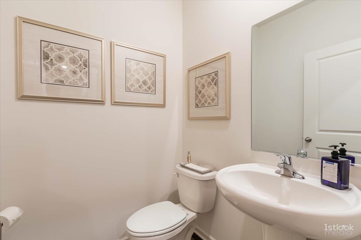 10453 Privet Drive St. John, IN 46307 - Photo 9 of 37 a bathroom with a toilet sink and mirror