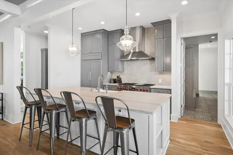 a kitchen with stainless steel appliances granite countertop a stove a refrigerator a oven a sink with a dining table and chairs