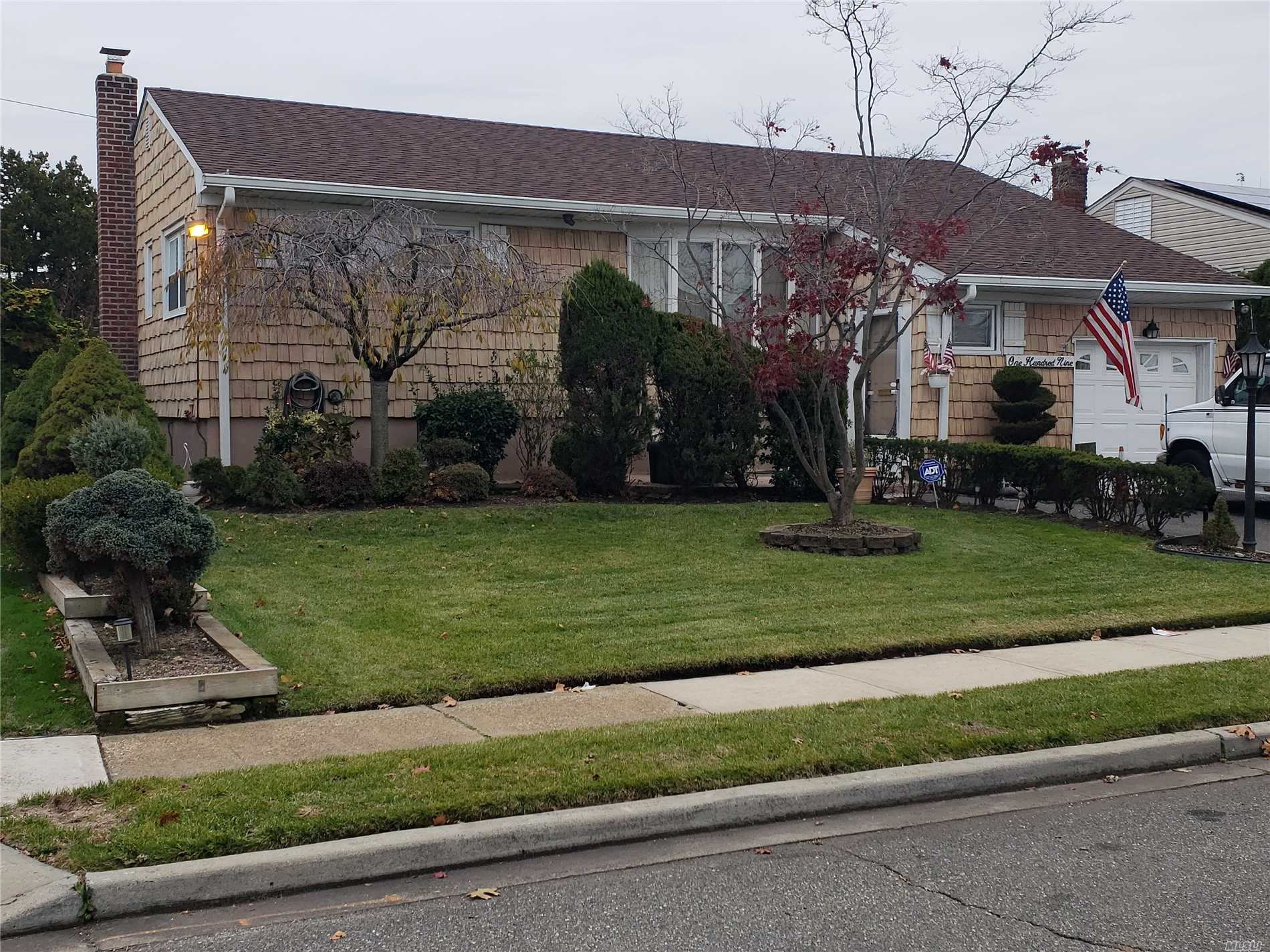 109 Forest Road Valley Stream, NY 11581 - Photo 1 of 1 a front view of a house with a yard