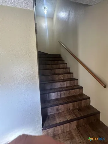 a view of hallway with wooden floor