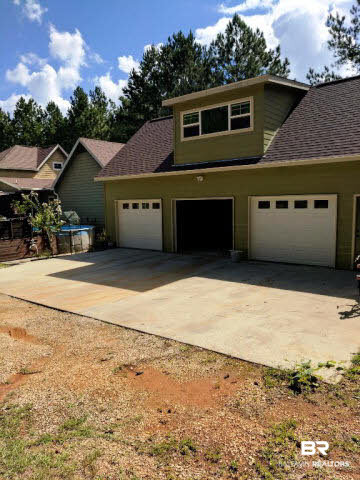 13848 Elmwood Court Stapleton, AL 36578 - Photo 25 of 27 Huge 3 car detached garage with overhead storage already roughed in for expansion. Could have additional living space or make it a hobby art space.