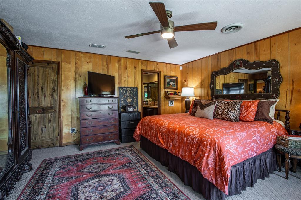 2043 Huddleston Road Sunset, TX 76270 - Photo 13 of 36 a bedroom with a bed and a flat screen tv