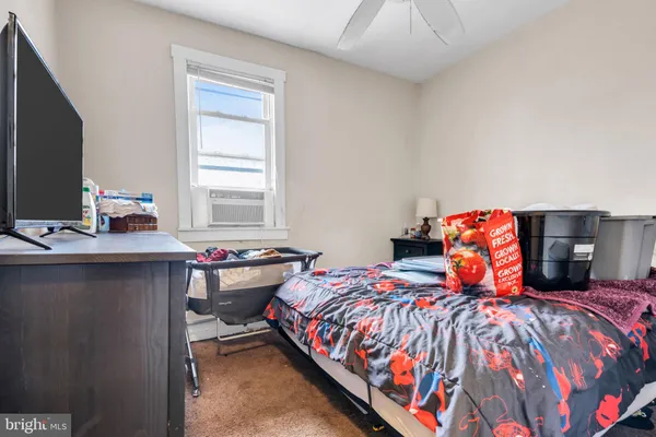 a bedroom with a bed and a tv