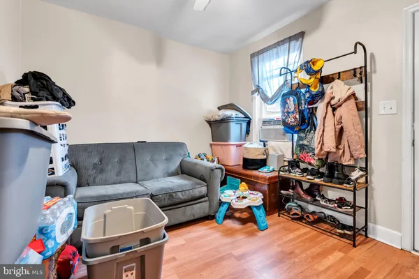 a living room with furniture and a gym machine