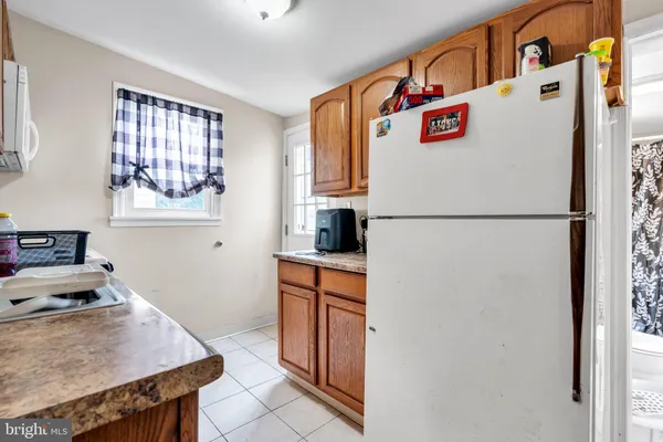 a white refrigerator freezer sitting inside of a kitchen