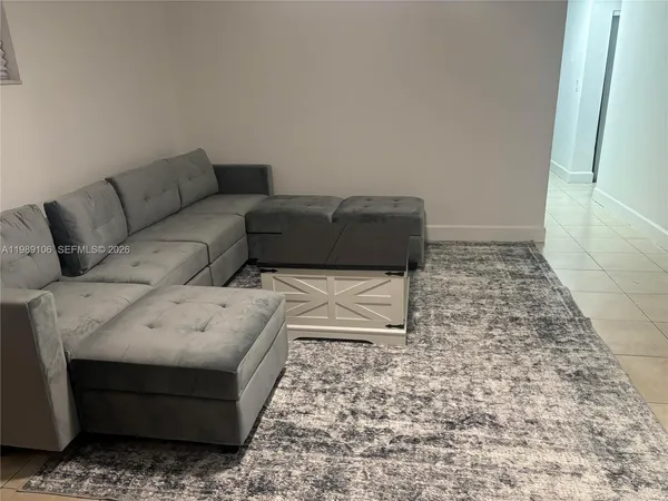 a living room with furniture and a rug