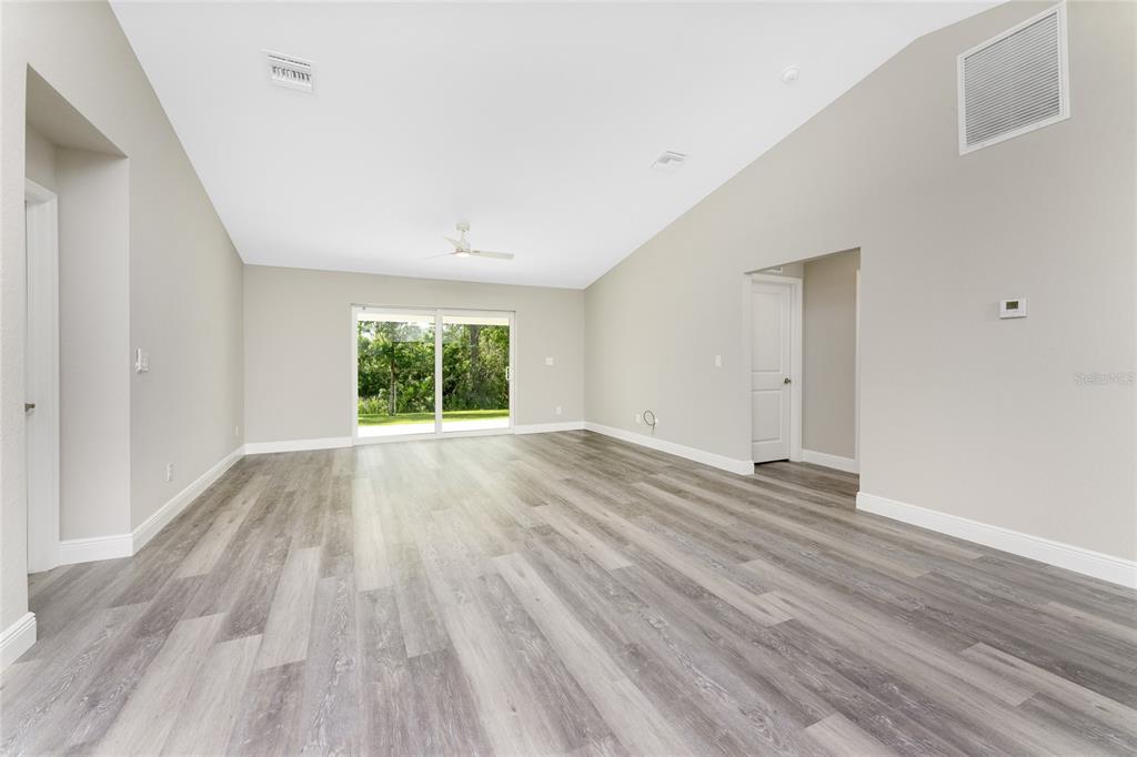 6397 Filbert Street North Port, FL 34288 - Photo 13 of 71 wooden floor in an empty room with a window