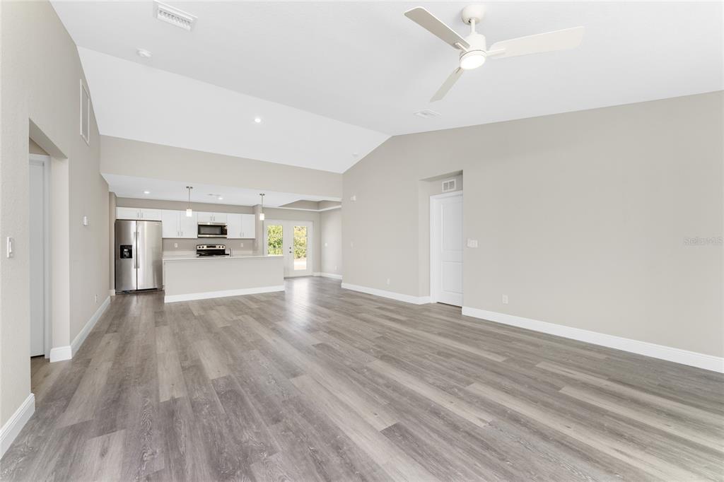 6397 Filbert Street North Port, FL 34288 - Photo 18 of 71 a view of a hallway with wooden floor and a refrigerator
