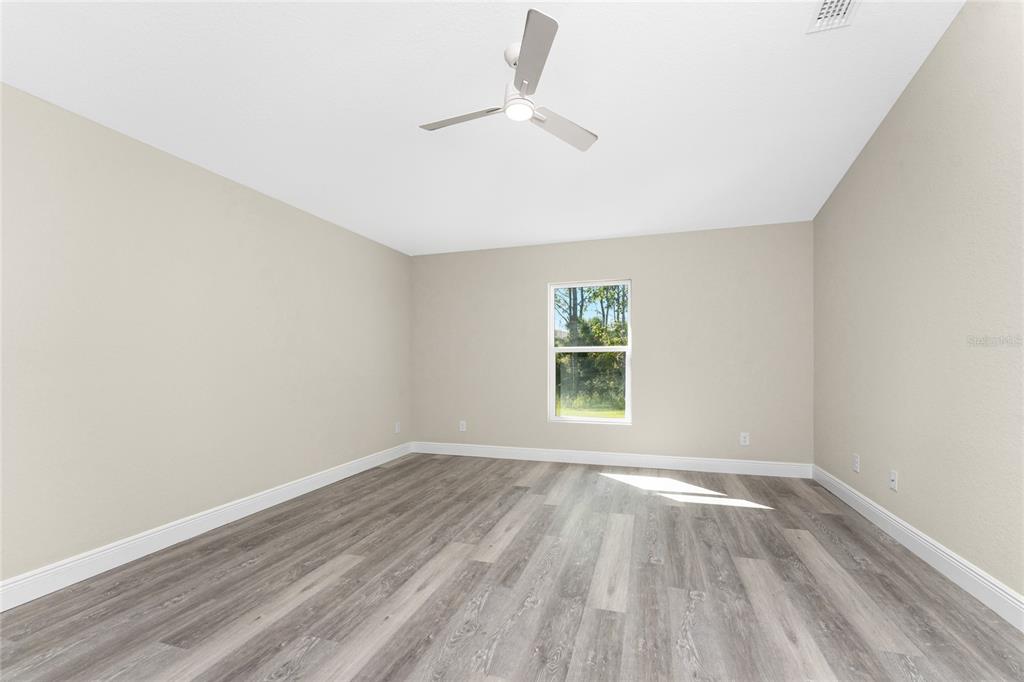 6397 Filbert Street North Port, FL 34288 - Photo 27 of 71 wooden floor in an empty room with a window