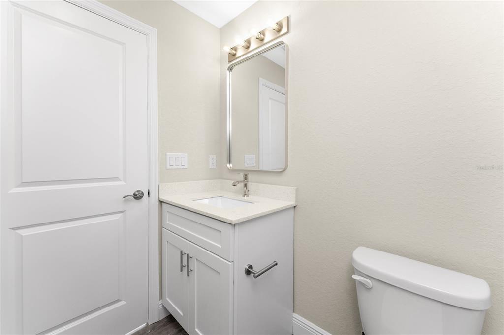 6397 Filbert Street North Port, FL 34288 - Photo 36 of 71 a bathroom with a toilet a sink a vanity and mirror