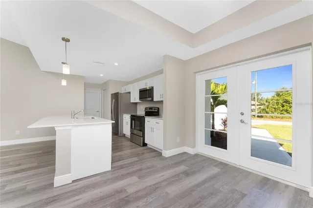 a kitchen with stainless steel appliances a refrigerator sink and microwave