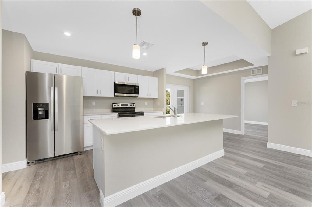 6397 Filbert Street North Port, FL 34288 - Photo 7 of 71 a kitchen with stainless steel appliances a refrigerator sink and microwave