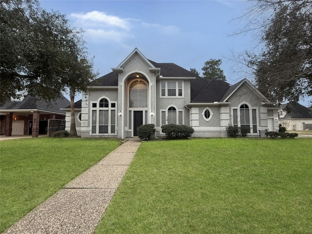 a front view of a house with a garden and yard