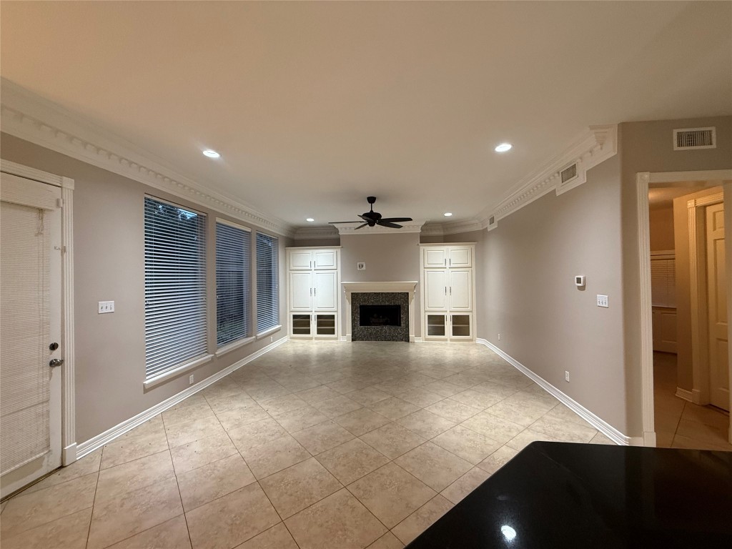 13523 Pegasus Road Cypress, TX 77429 - Photo 12 of 36 a view of an empty room with a fireplace and a window