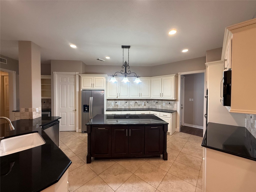 13523 Pegasus Road Cypress, TX 77429 - Photo 15 of 36 a kitchen with stainless steel appliances granite countertop a stove a sink a refrigerator and a fireplace