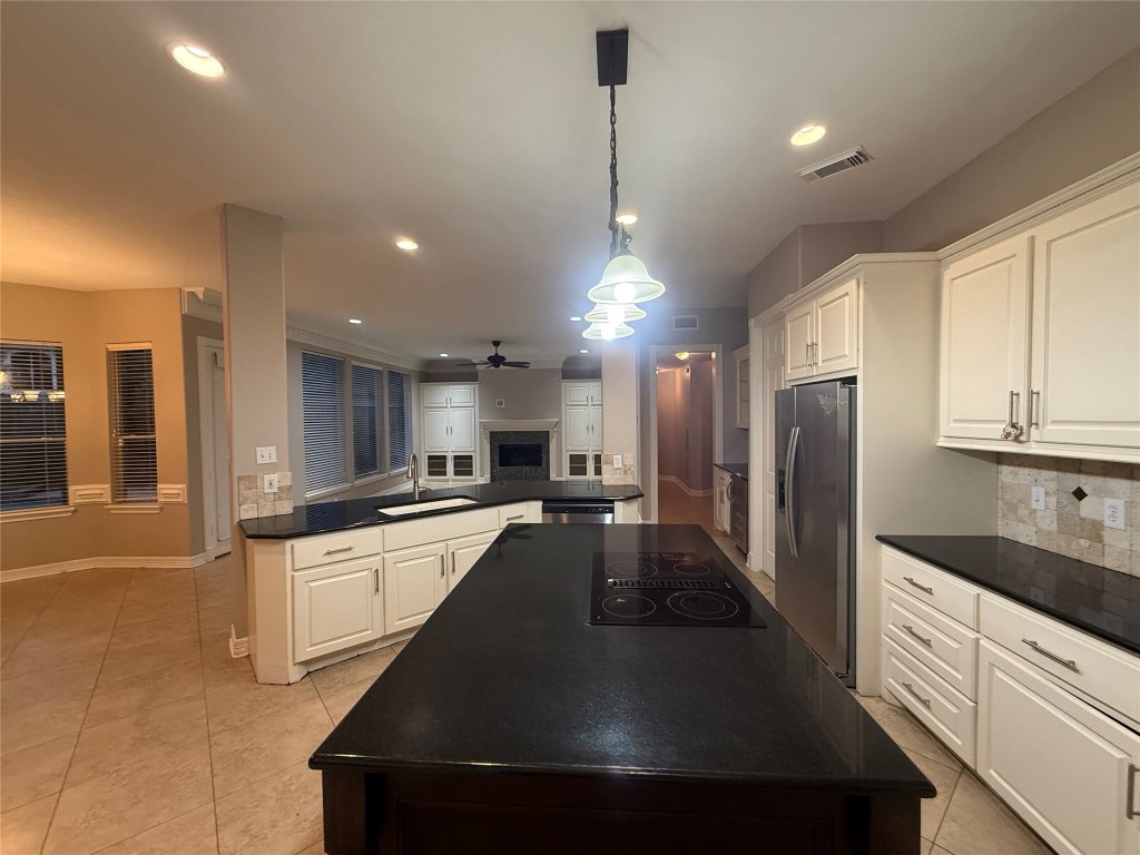 13523 Pegasus Road Cypress, TX 77429 - Photo 16 of 36 a kitchen with stainless steel appliances a refrigerator sink and cabinets