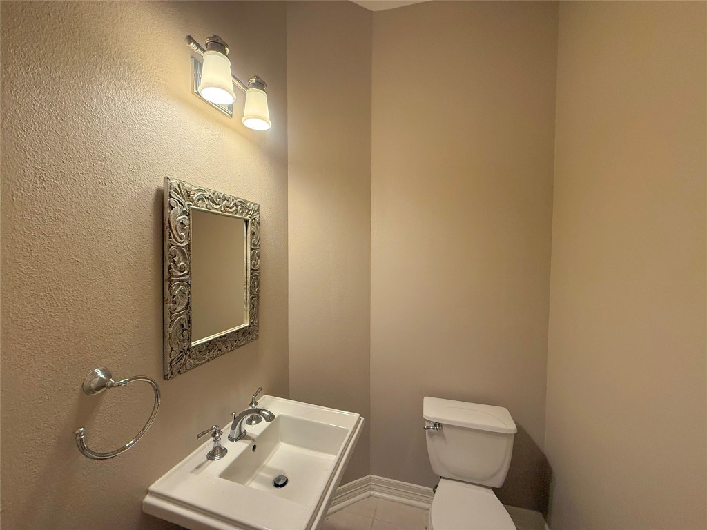 13523 Pegasus Road Cypress, TX 77429 - Photo 25 of 36 a bathroom with a toilet sink vanity and mirror